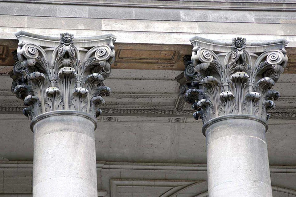 Two stone columns with carved Corinthian capitals.